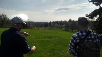 Mark Beatty on left, John on right overlooking the former orchard location on campus.